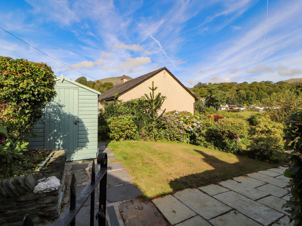 A garden with a shed and plants at Sunbeam Cottage in Coniston