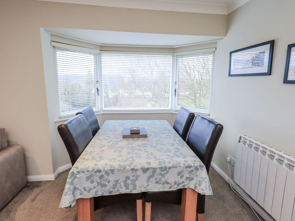 A dining room with a table and chairs at Lakeland Loft in Windermere