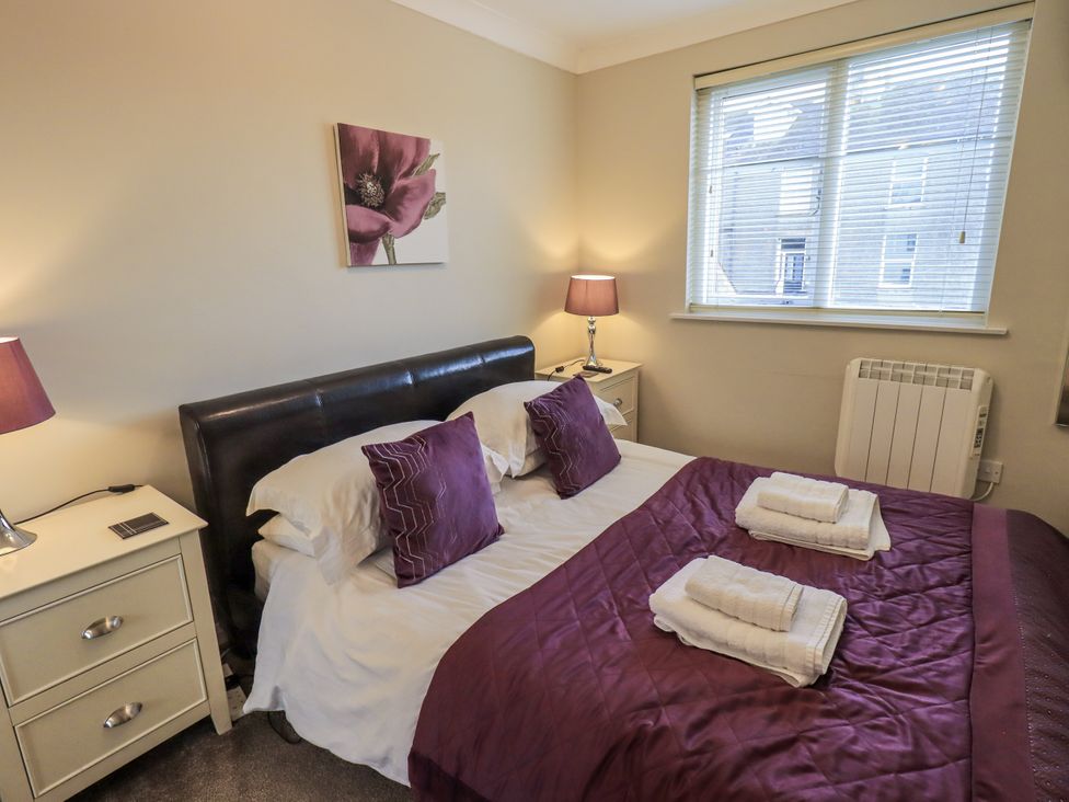 A bedroom with a bed and nightstands at Lakeland Loft in Windermere