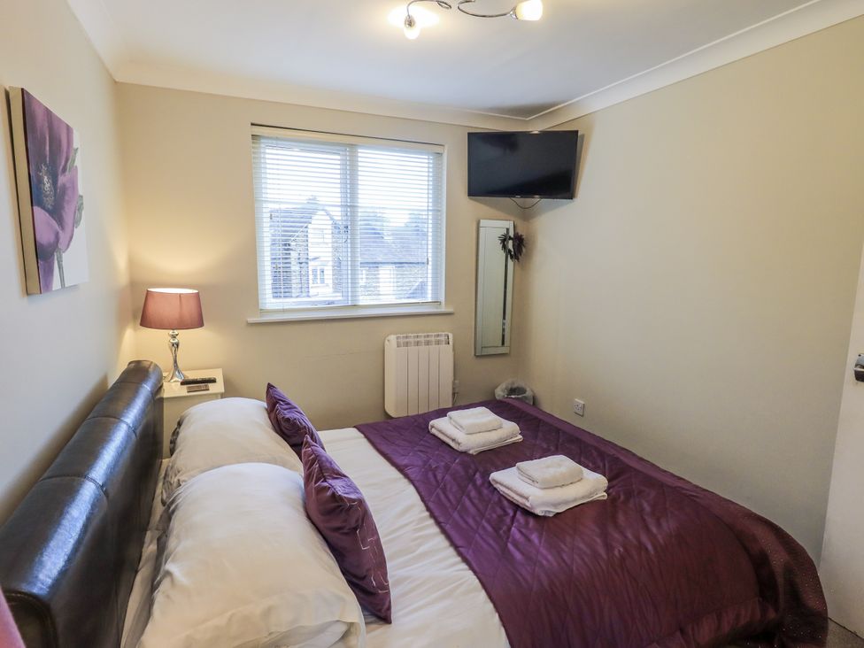 A bedroom with a bed and television at Lakeland Loft Windermere