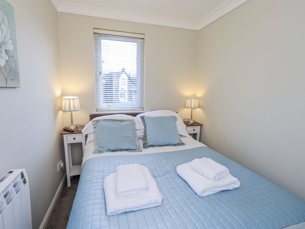 A bedroom with a bed and nightstands at Lakeland Loft Windermere