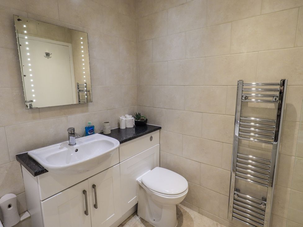A bathroom with sink and toilet at Lakeland Loft in Windermere