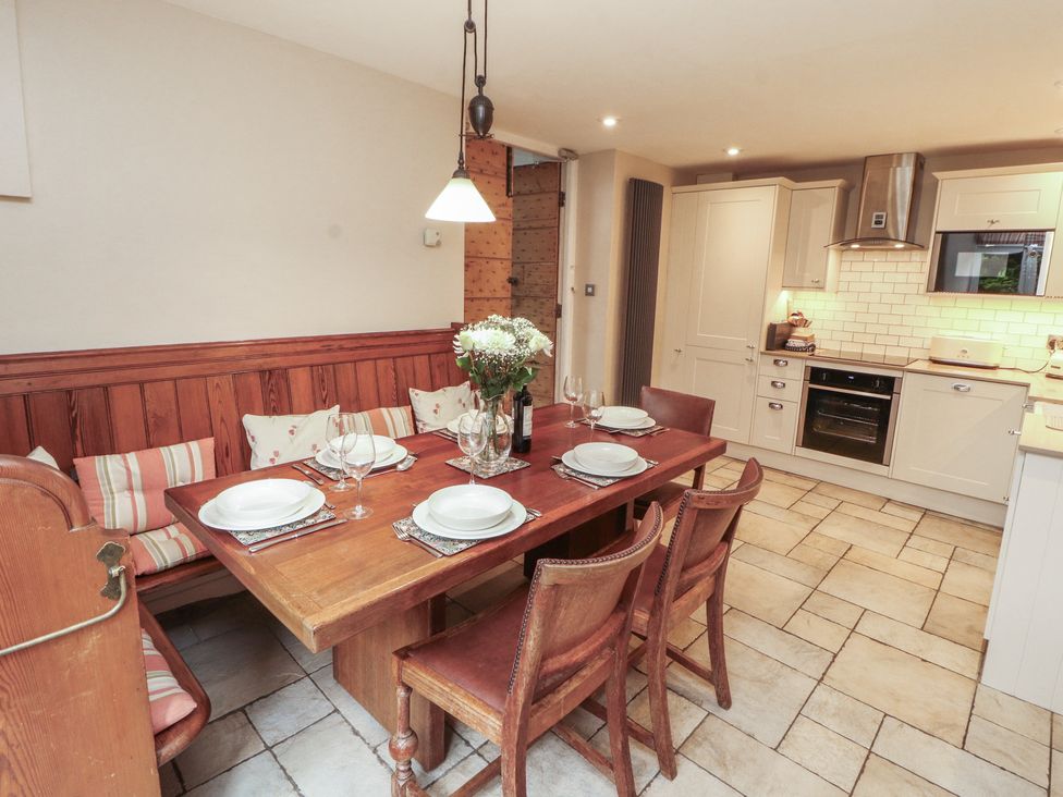A kitchen with a dining table and chairs at Chapel How in Ambleside