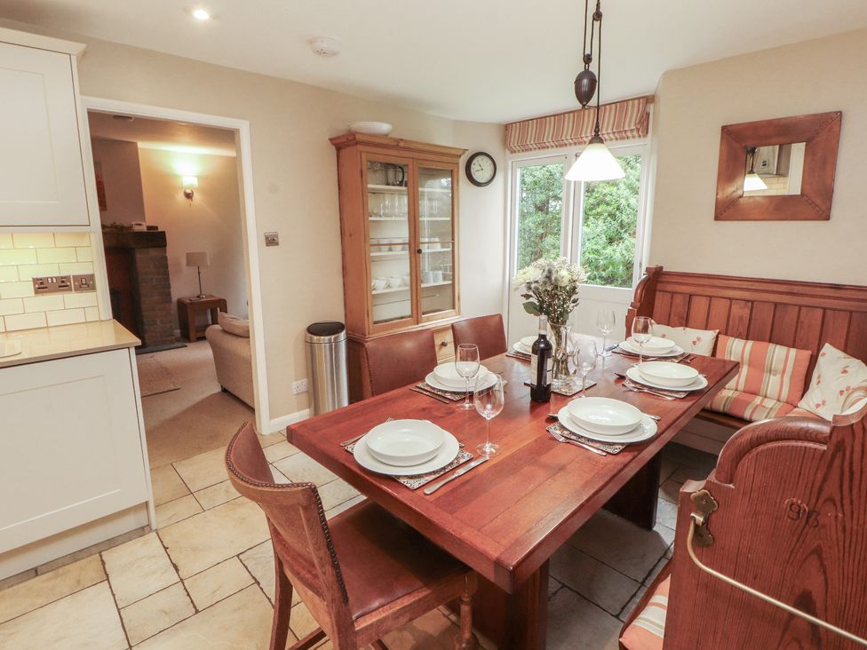 A dining room with a wooden table and chairs at Chapel How in Ambleside