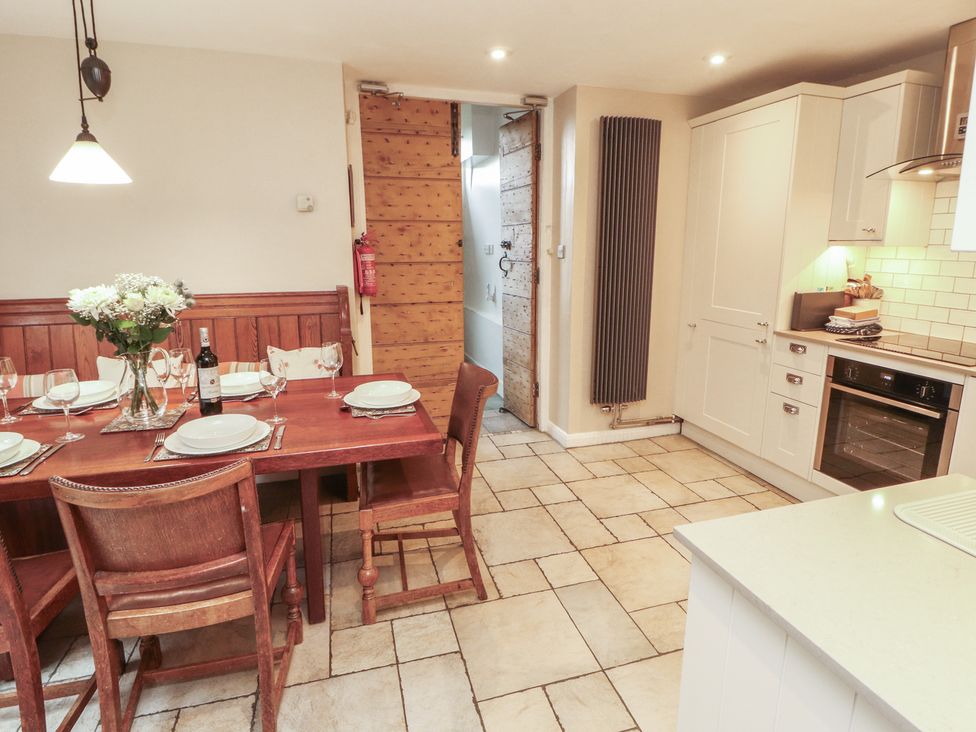 A kitchen with a dining table and chairs at Chapel How in Ambleside