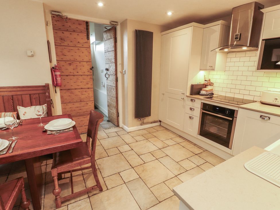 A kitchen with a dining table and chairs at Chapel How in Ambleside