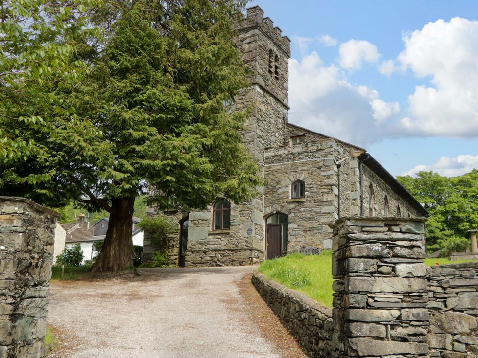 A building with stone walls and a gravel path at Chapel How in Ambleside