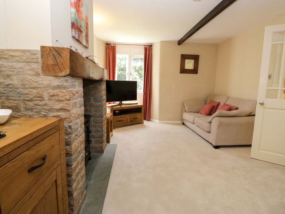 A living room with a sofa and television at Chapel How in Ambleside