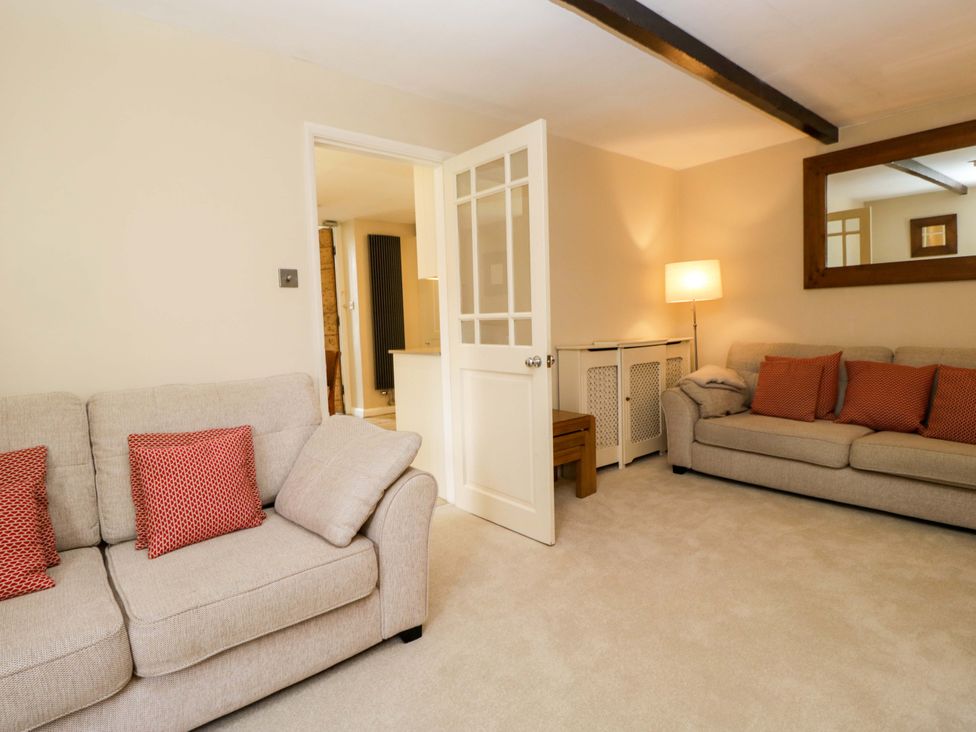 A living room with a sofa and lamp at Chapel How in Ambleside