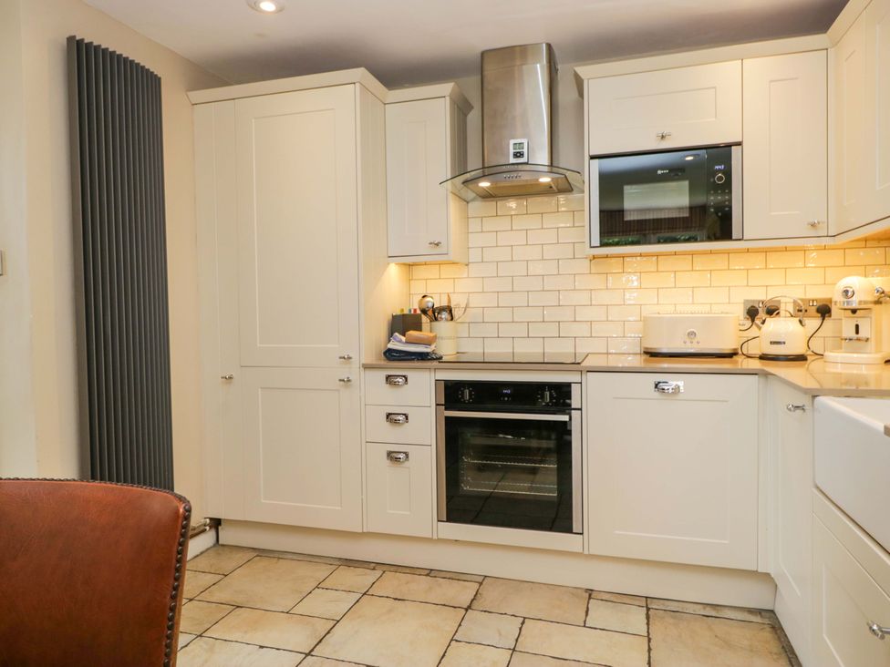 A kitchen with cabinets and appliances at Chapel How in Ambleside