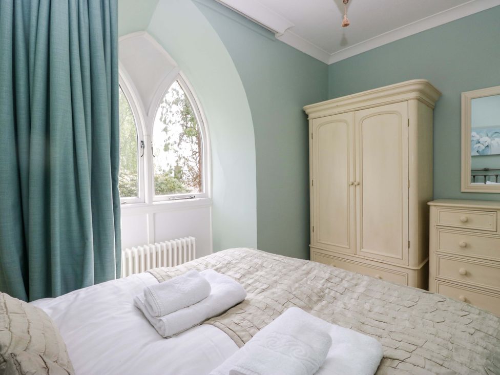 A bedroom with a bed and wardrobe at Chapel How in Ambleside
