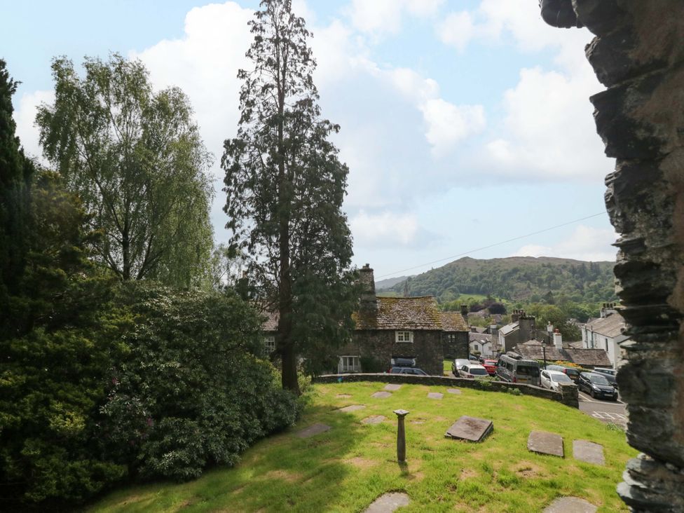A view of a garden with trees and houses at Chapel How Ambleside