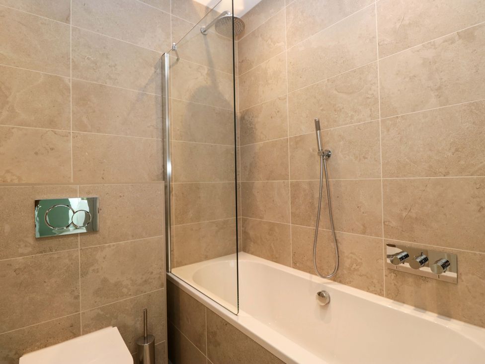 A bathroom with a bathtub and shower at Chapel How Ambleside