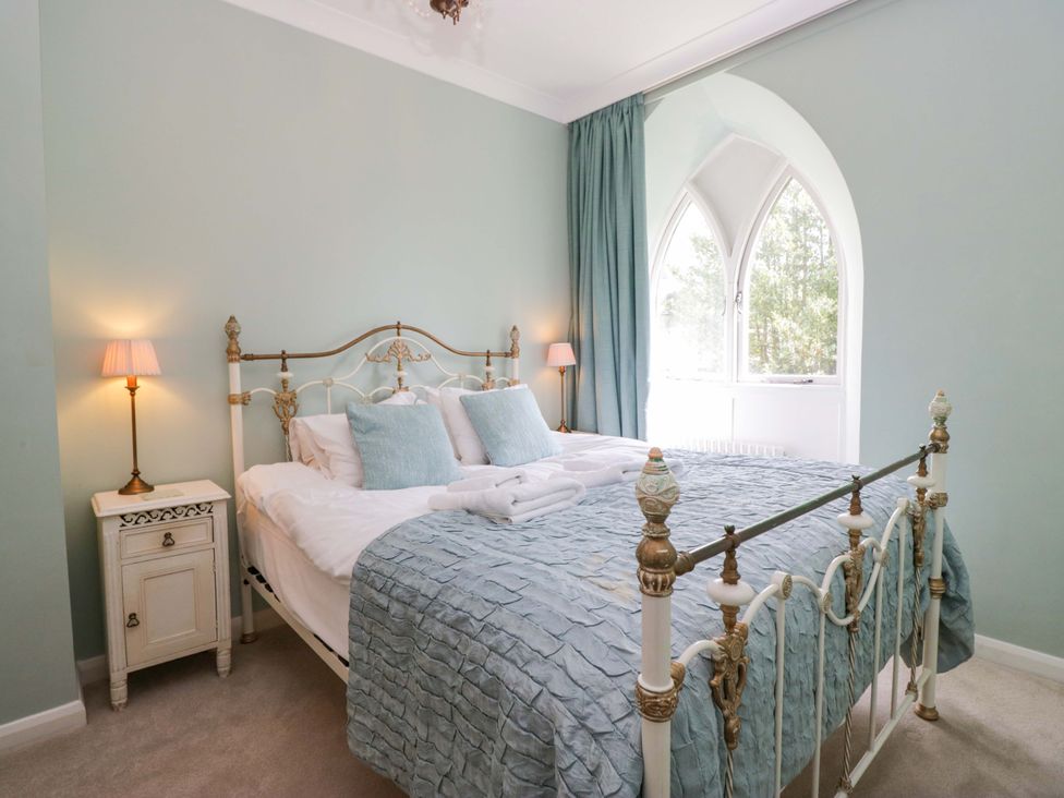 A bedroom with a bed and lamps at Chapel How in Ambleside