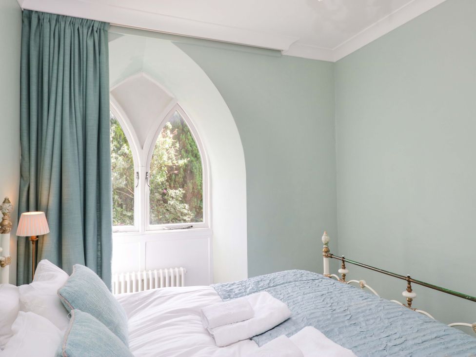 A bedroom with a bed and window at Chapel How in Ambleside