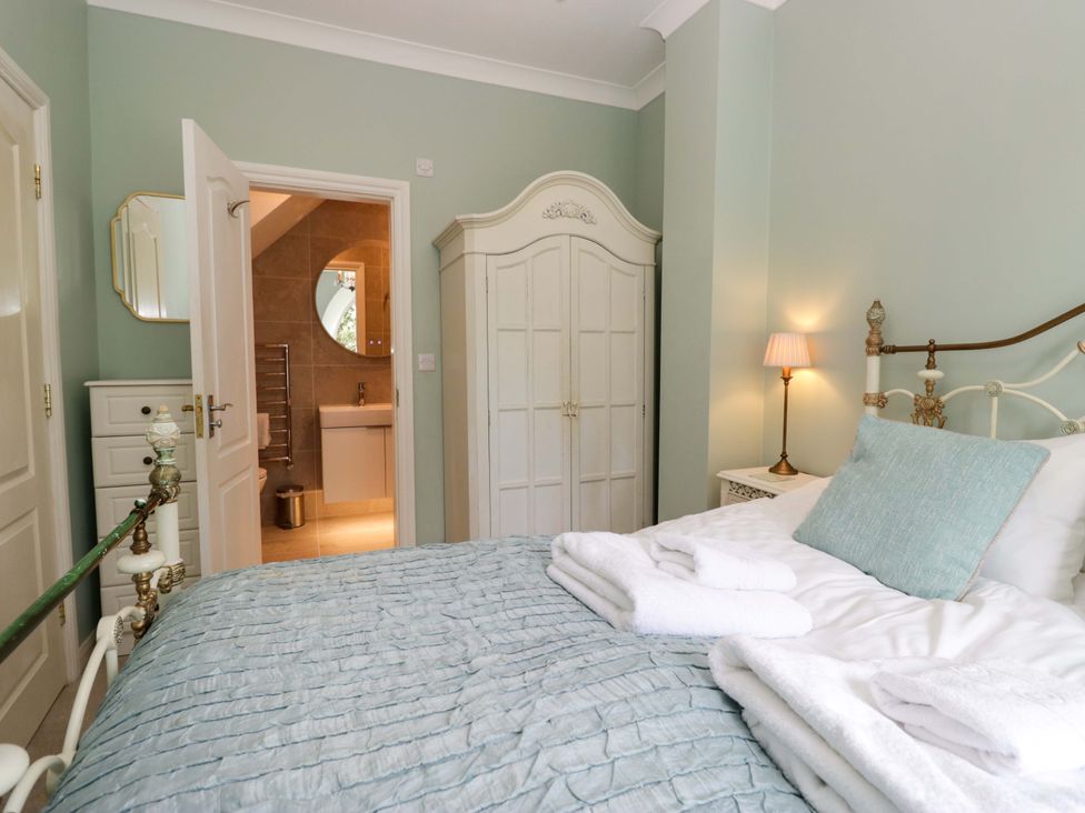 A bedroom with bed and wardrobe at Chapel How in Ambleside