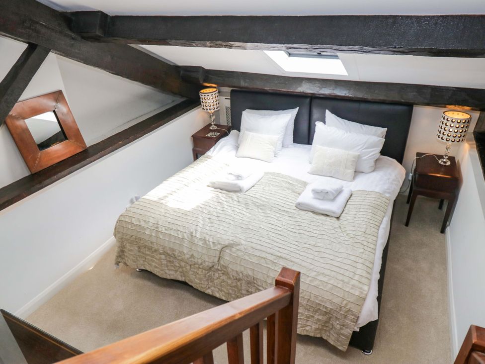 A bedroom with a bed and bedside tables at Chapel How Ambleside