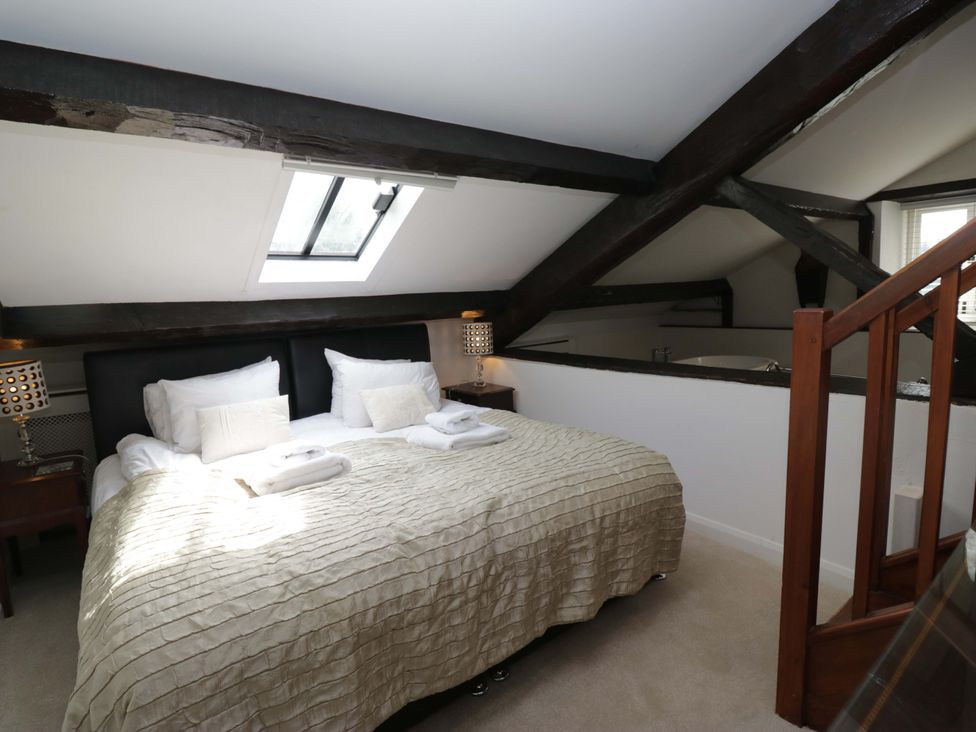 A bedroom with a bed and lamps at Chapel How in Ambleside