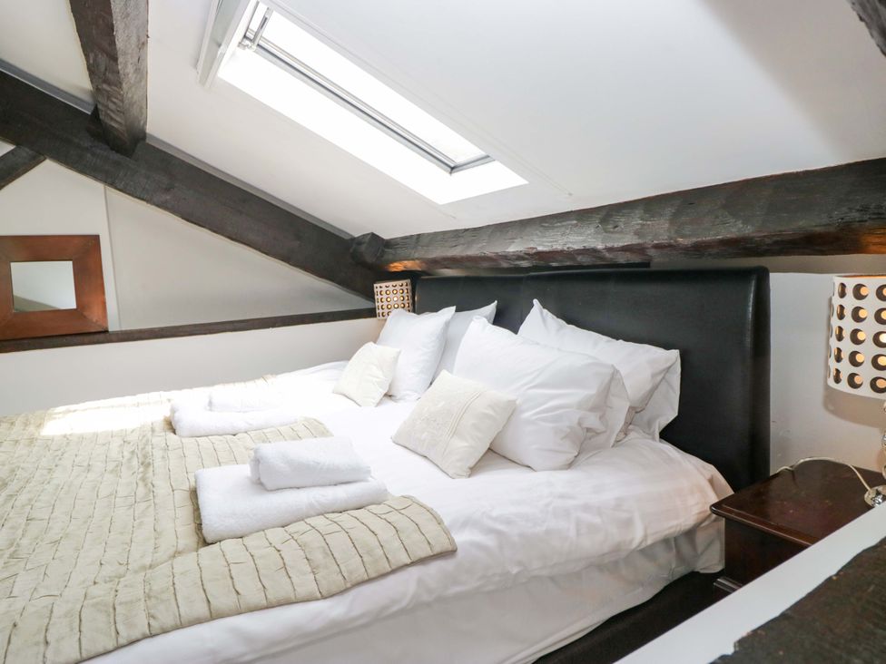 A bedroom with a bed and a lamp at Chapel How in Ambleside