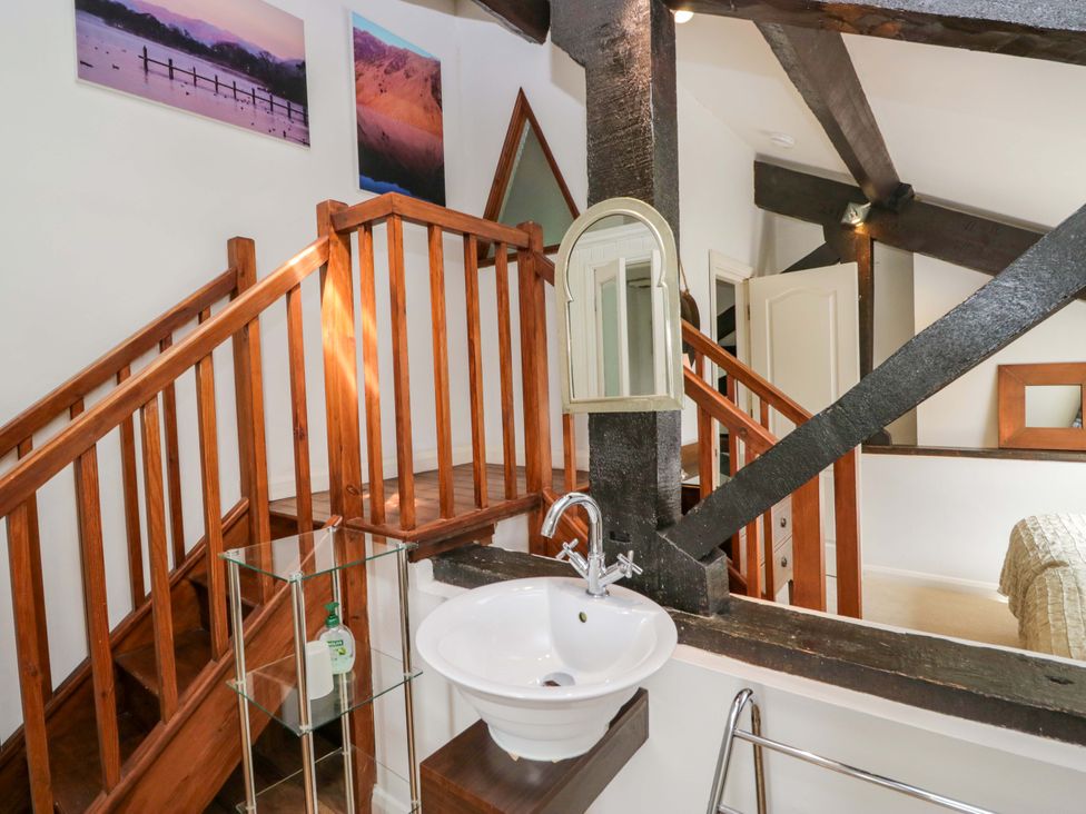A room with a staircase and sink at Chapel How in Ambleside