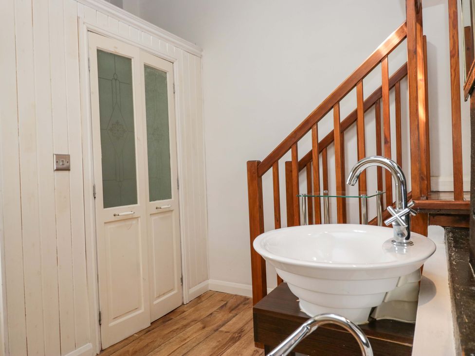 A bathroom with a sink and stairs at Chapel How Ambleside
