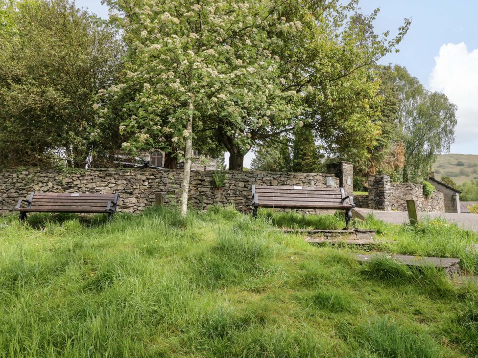 A park with benches and trees at Chapel How in Ambleside