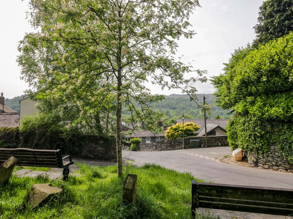 A street view with a tree and benches at Chapel How in Ambleside