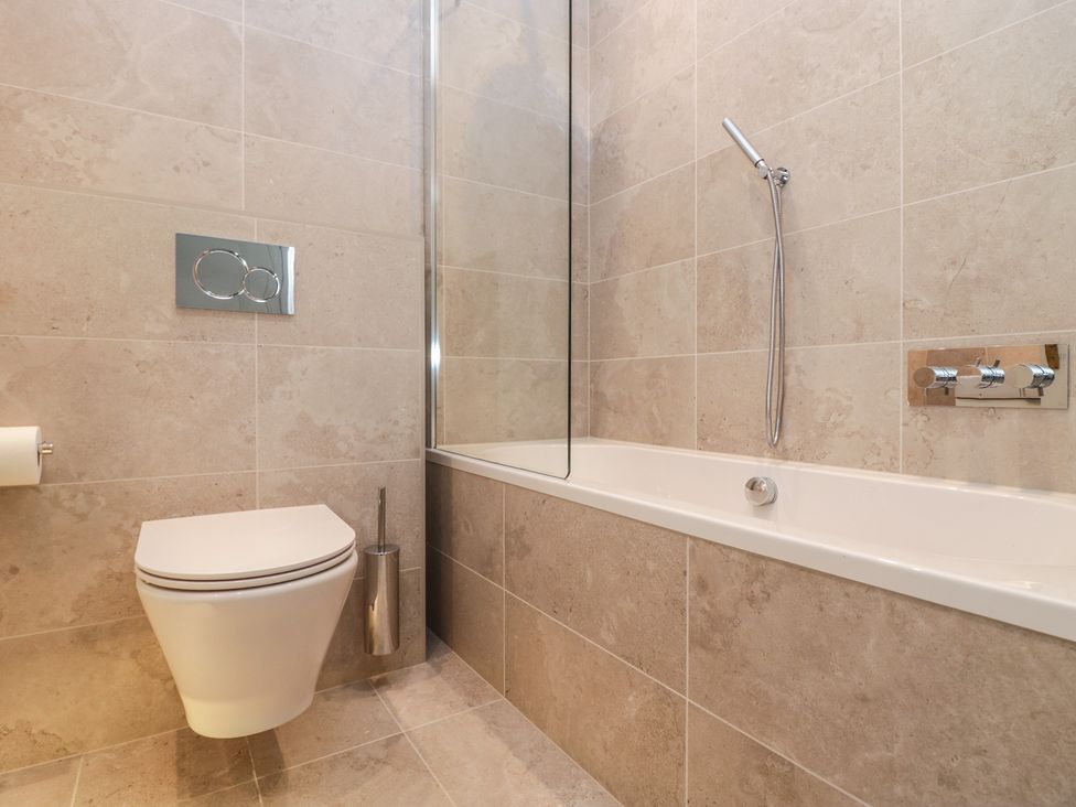 A bathroom with a toilet and bathtub at Chapel How in Ambleside