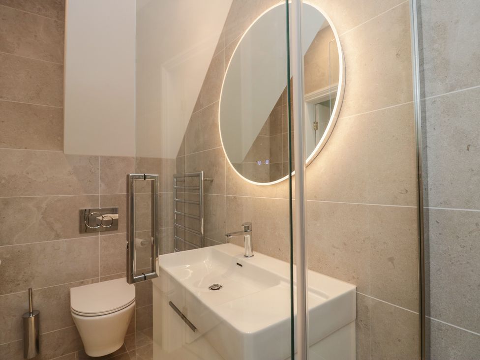 A bathroom with a sink, toilet, and shower at Chapel How in Ambleside