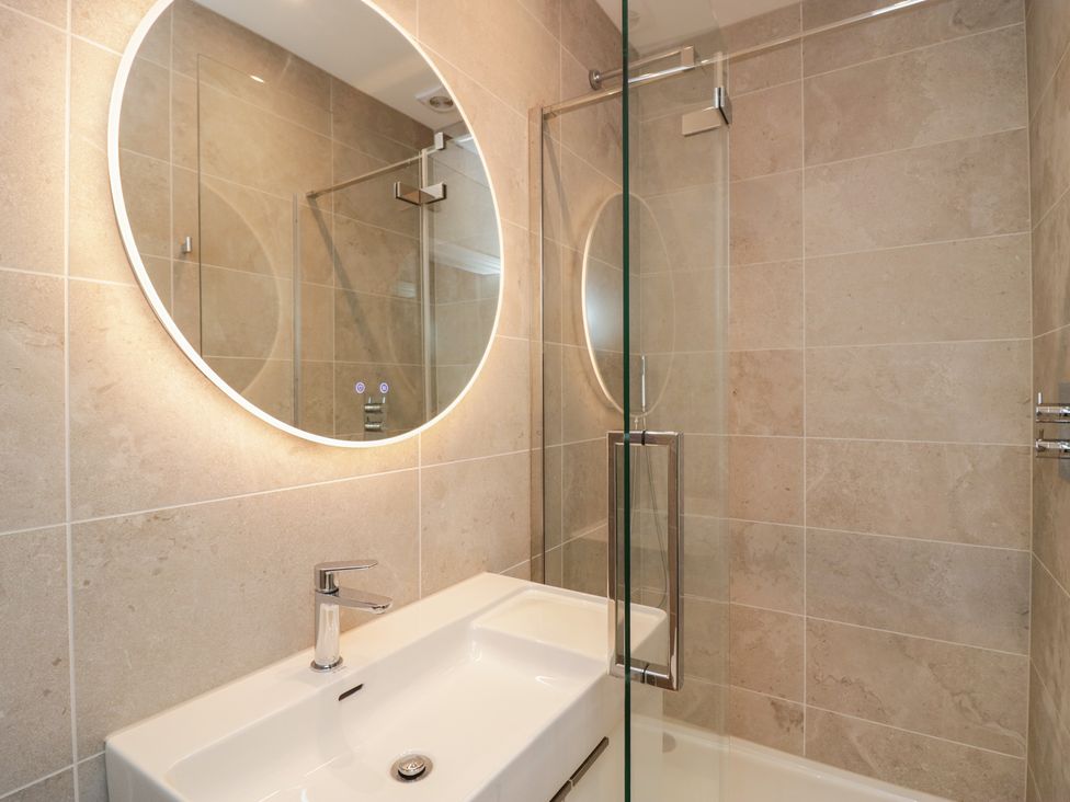 A bathroom with a sink and mirror at Chapel How in Ambleside