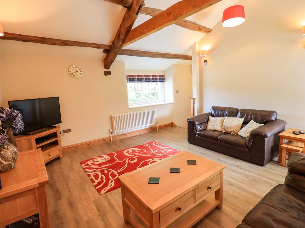 A living room with a sofa and television at Abbots Reading Mews 1 in Grizedale