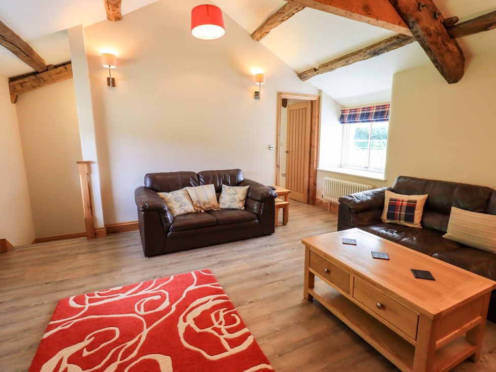 A living room with two sofas and a coffee table at Abbots Reading Mews 1 in Grizedale