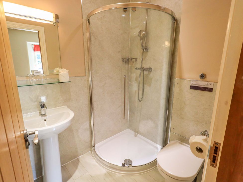 A bathroom with shower, sink, and toilet at Abbots Reading Mews 1 in Grizedale