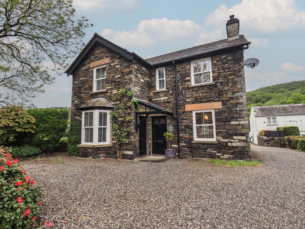 A house with stone walls and a gravel driveway at Newby Bridge House in Newby Bridge