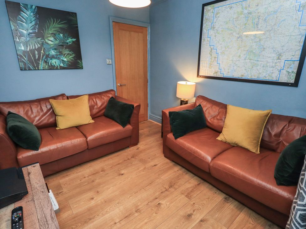 A living room with two sofas and a lamp at Newby Bridge House, Newby Bridge