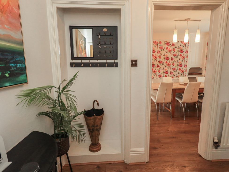 A hallway with a key holder and plant at Newby Bridge House, Newby Bridge