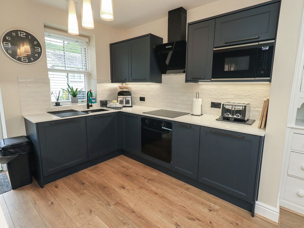 A kitchen with a sink and appliances at Newby Bridge House in Newby Bridge