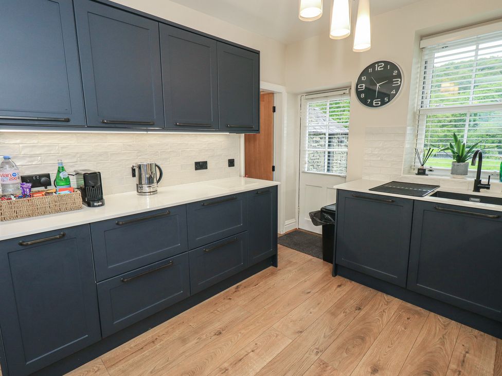 A kitchen with cabinets and appliances at Newby Bridge House in Newby Bridge