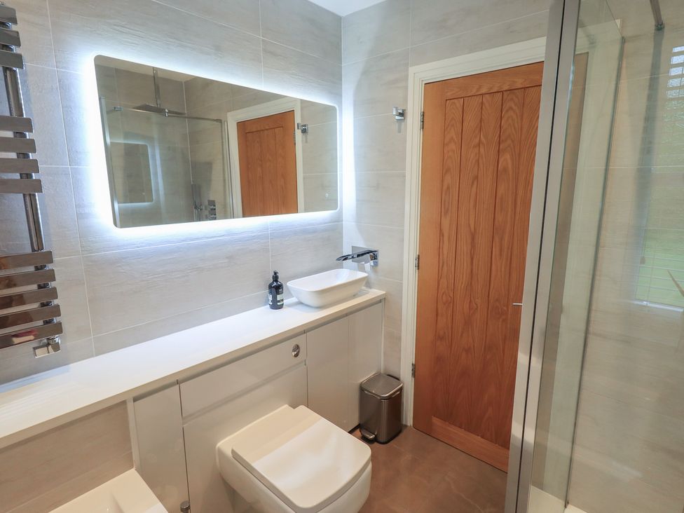A bathroom with a sink and toilet at Newby Bridge House in Newby Bridge