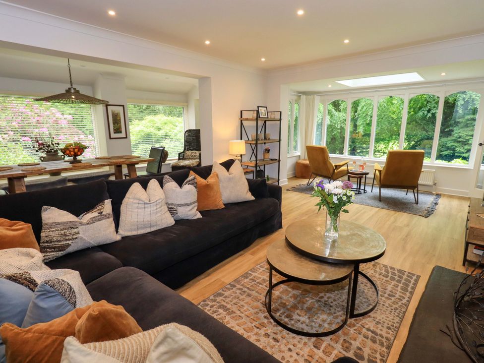 A living room with a sofa, coffee table, and chairs at Underheron in Grasmere