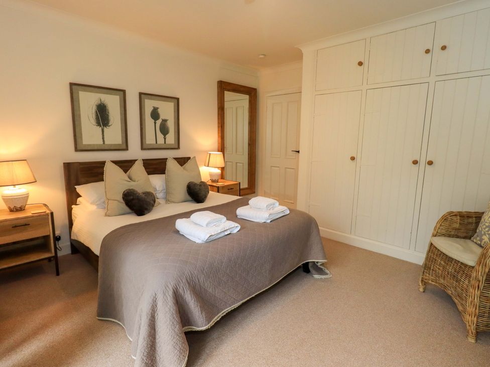 A bedroom with a bed and decorative wall art at Underheron in Grasmere