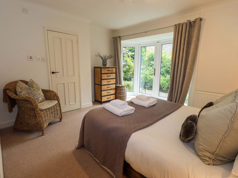 A bedroom with a bed and dresser at Underheron in Grasmere