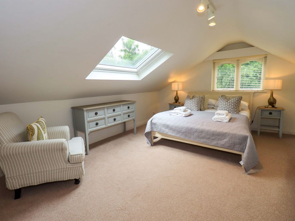 A bedroom with a bed and furniture at Underheron in Grasmere