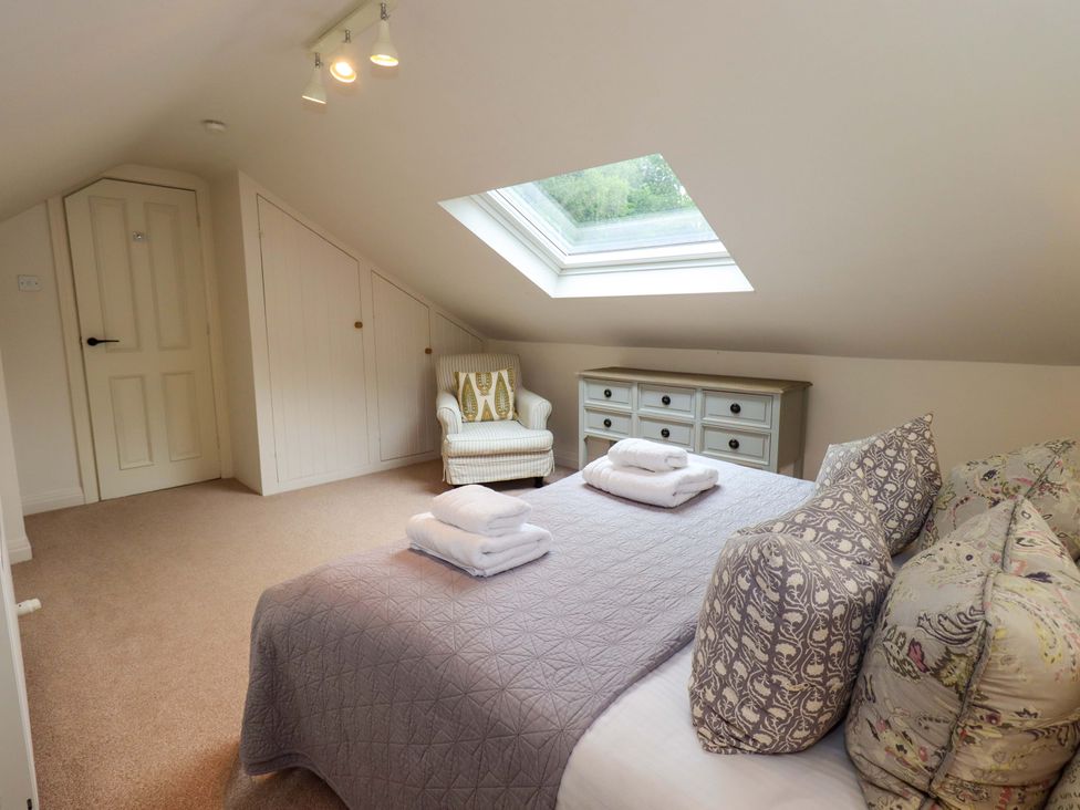 A bedroom with a bed and dresser at Underheron in Grasmere