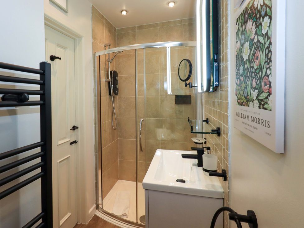 A bathroom with a shower and sink at Underheron in Grasmere
