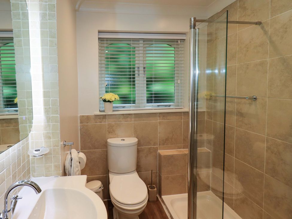 A bathroom with a toilet and a shower at Underheron in Grasmere