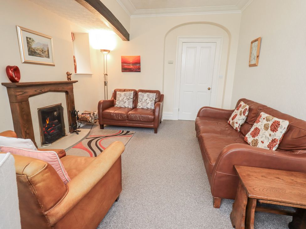 A living room with sofas and a fireplace at Miyanli in Bowness