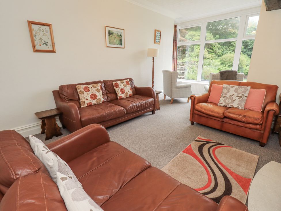 A living room with a sofa and armchair at Miyanli in Bowness