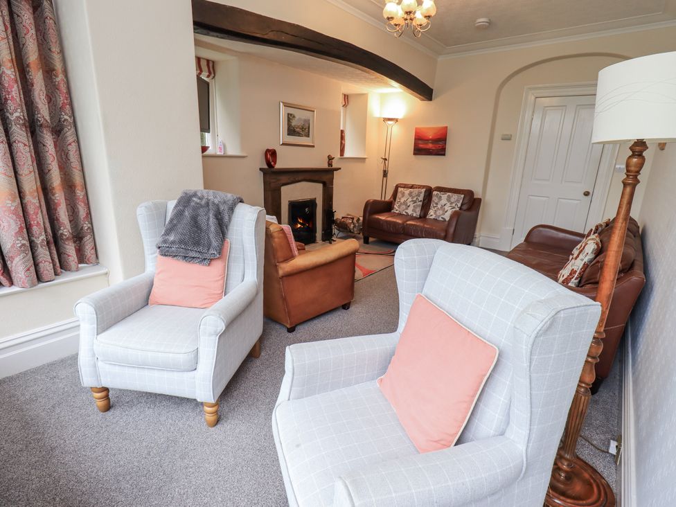 A living room with chairs and a fireplace at Miyanli in Bowness