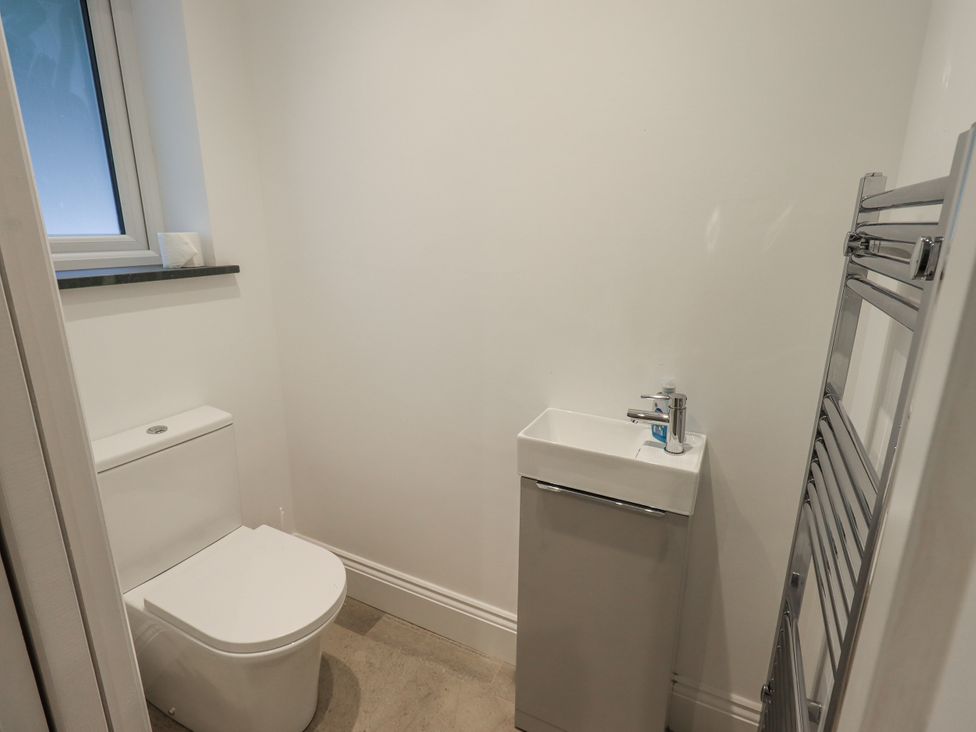 A bathroom with a toilet and sink at Miyanli in Bowness
